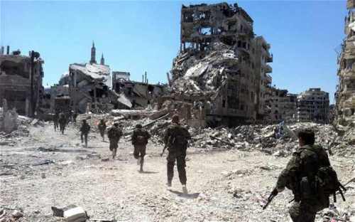 Syrian government forces patrol the Khalidiyah neighbourhood of Homs, mid-2013. Photo: AFP/Getty Images